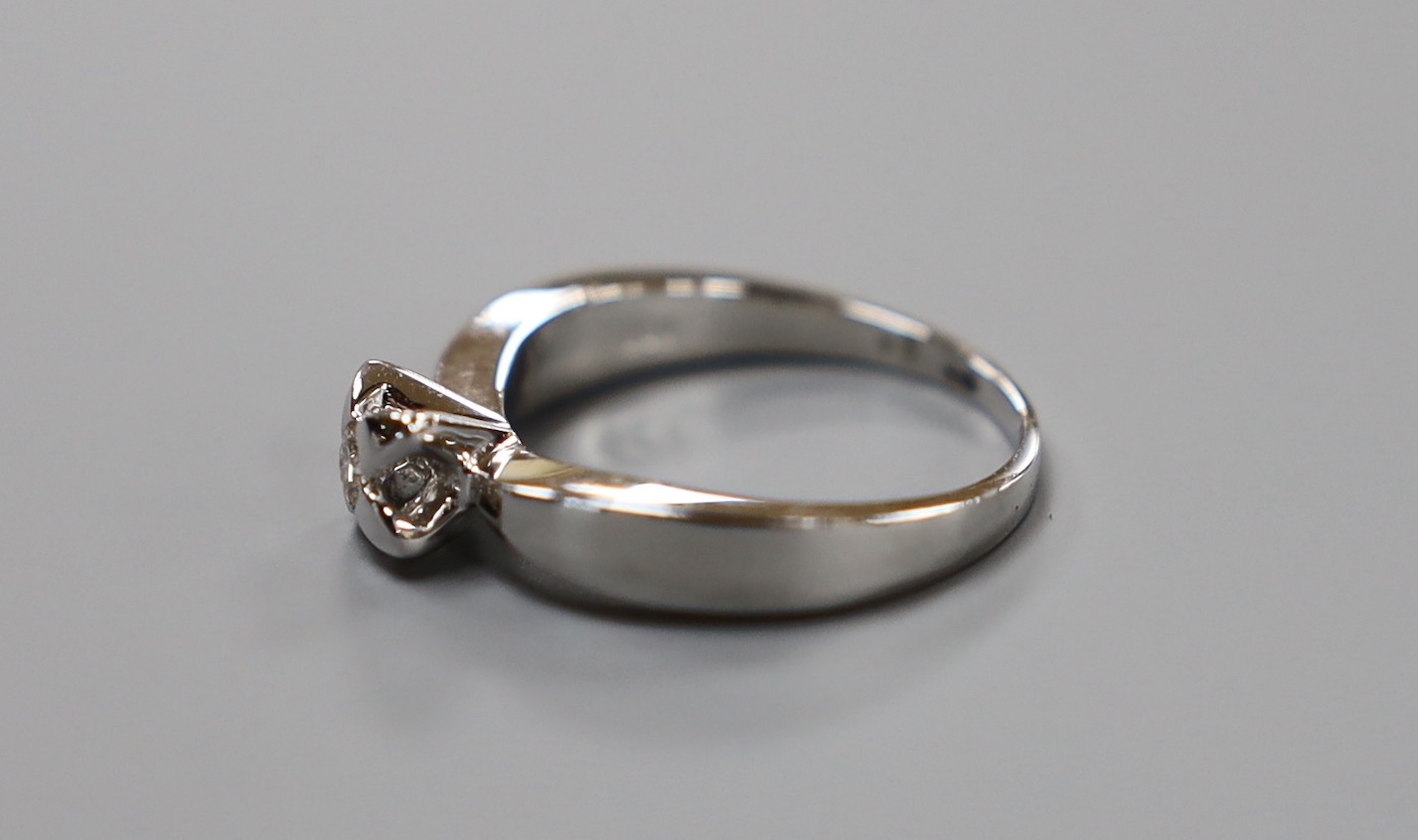 A modern platinum and single stone diamond set ring, size N, gross weight 6 grams